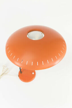 The reflector of an orange table lamp by probably Louis Kalff for Philips Eindhoven
