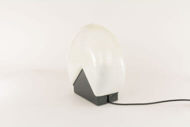 A glass table lamp by Roberto Pamio for Leucos as seen from one side