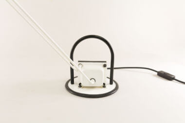 The base of a halogen adjustable white table lamp with black details from Italy