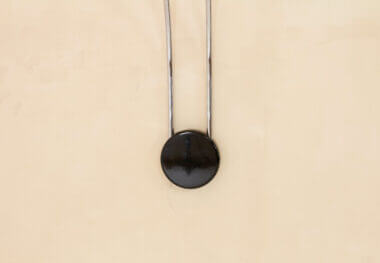 A black Gesto wall lamp by Bruno Gecchelin for Skipper attached to the wall