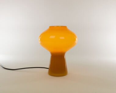 Hand-blown amber Fungo table lamp (medium) by Massimo Vignelli for Venini, switched on