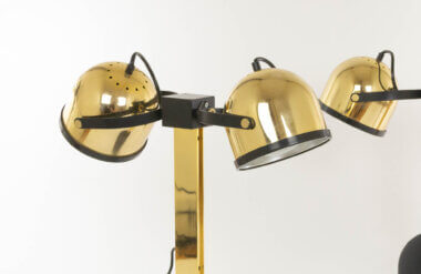 The reflectors of a pair of brass Trepiù table lamps by Gae Aulenti and Livio Castiglioni for Stilnovo