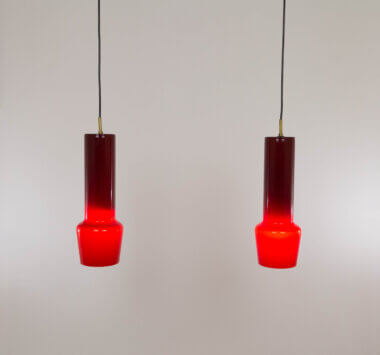 Pair of red glass pendants by Massimo Vignelli for Venini, switched on