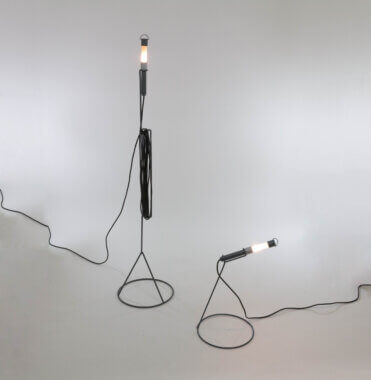 A pair of Edy lamps by Piero Castiglioni for Fontana Arte, switched on