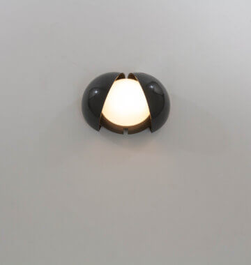 A grey Lampira wall lamps by G.P.A. Monti for Fontana Arte, switched on